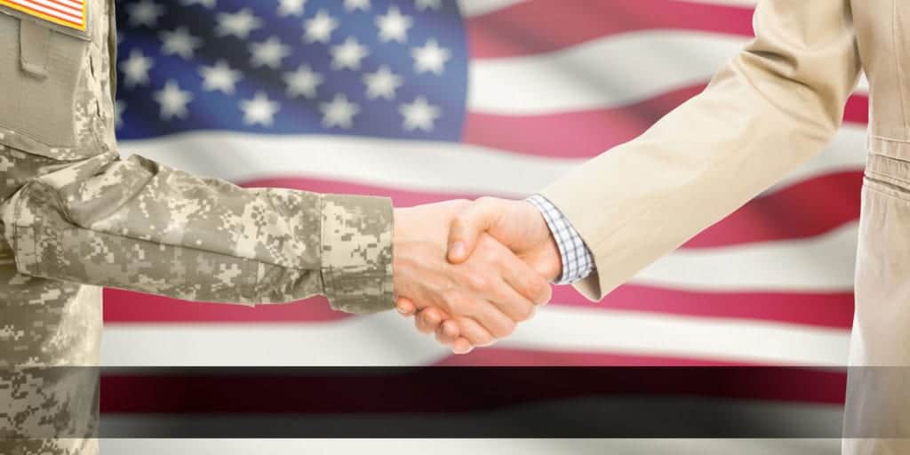 Soldier shaking hands with a civilian