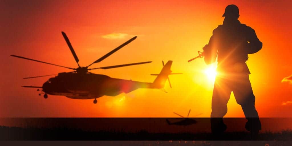 Soldier in front of a helicopter