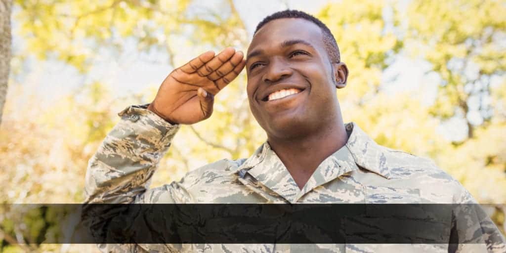 Soldier saluting among trees