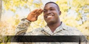Soldier saluting among trees