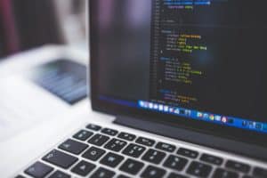 Laptop screen showing HTML code