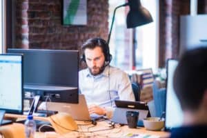 Man in office shirt working at a desk